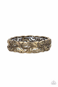 Antiqued brass paisley patterned frames are threaded along stretchy bands around the wrist, creating a rustic centerpiece.  Sold as one individual bracelet.