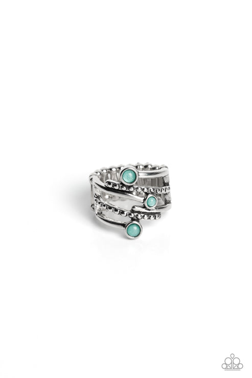 Dotted with silver studs and light green beads with an abundance of shimmer, stacks of silver bands crisscross and wrap across the front of the finger for a jaw-dropping dazzle. Features a stretchy band for a flexible fit.  Sold as one individual ring.