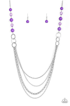 Polished purple, faceted crystal-like and delicately hammered silver hoops give way to mismatched silver chains down the chest for a whimsical look. Features an adjustable clasp closure. Sold as one individual necklace. Includes one pair of matching earrings.