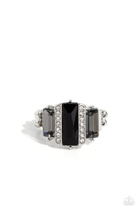 Bordered by two rows of dainty white rhinestones, an emerald cut black rhinestone adorns the center of a band dotted with a pair of smoky emerald cut rhinestones, resulting into a jaw-dropping dazzle across the finger. Features a stretchy band for a flexible fit.  Sold as one individual ring.