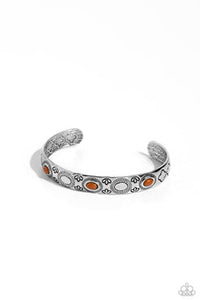 A trio of oval Adobe beads are pressed into the centers of shimmery sunbursts stamped across the front of a dainty silver cuff radiating with desert patterns, creating an earthy pop of color around the wrist.  Sold as one individual bracelet.