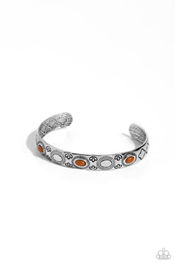 A trio of oval Adobe beads are pressed into the centers of shimmery sunbursts stamped across the front of a dainty silver cuff radiating with desert patterns, creating an earthy pop of color around the wrist.  Sold as one individual bracelet.