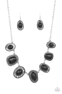 An earthy collection of irregular shaped black stones are each pressed into distinctive antiqued silver frames. Each frame showcases a unique pattern of studded and dotted texture resulting in an exclusive artisanal vibe. Features an adjustable clasp closure.  Sold as one individual necklace. Includes one pair of matching earrings.