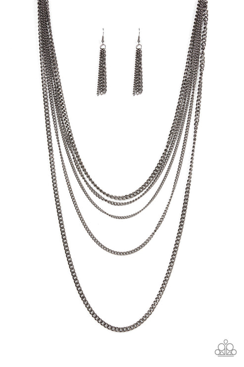An intense display of mismatched gunmetal chains boldly layer across the chest, resulting in an edgy industrial vibe. Features an adjustable clasp closure.  Sold as one individual necklace. Includes one pair of matching earrings.
