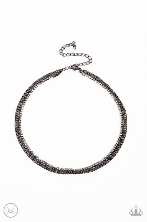 Two glistening gunmetal chains and a single strand of dainty white rhinestones effortlessly layer around the neck, resulting in a radiant look. Features an adjustable clasp closure.  Sold as one individual choker necklace. Includes one pair of matching earrings.