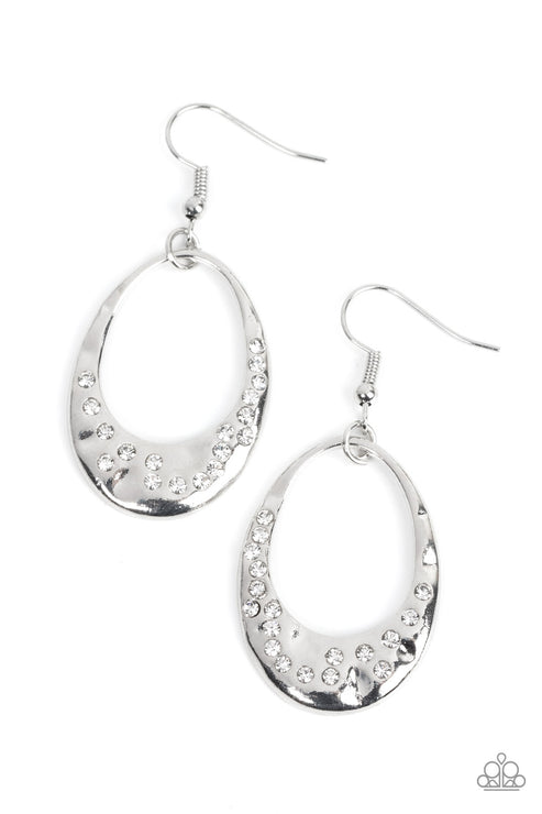 The flattened bottom of a hammered silver teardrop is sporadically dotted in glassy white rhinestones, resulting in a rustic sparkle. Earring attaches to a standard fishhook fitting.  Sold as one pair of earrings.