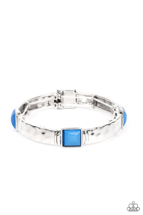 Dotted with a square blue beaded accent, a shimmery series of hammered silver frames are delicately threaded along stretchy bands around the wrist for an adventurous pop of color.  Sold as one individual bracelet.