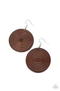 A shiny brown wooden disc is engraved in circular details, resulting in a dizzying pop of color. Earring attaches to a standard fishhook earring.  Sold as one pair of earrings.