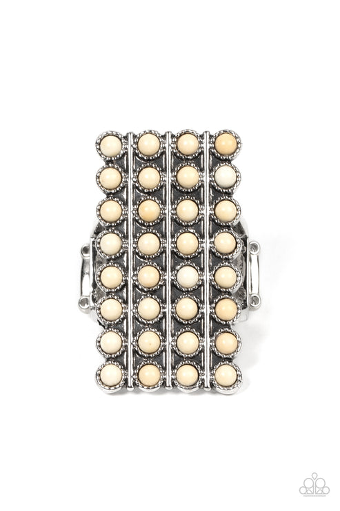 Bordered in antiqued silver studs, rows of dainty white stones boldly stack up the finger across the front of an oversized rectangular silver frame for an earthy vibe atop the finger. Features a stretchy band for a flexible fit.  Sold as one individual ring.