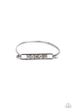 Encased in gunmetal square fittings, a row of glassy white rhinestones are fitted in place along an airy gunmetal frame that hinges to the center of a bangle-like bracelet for a timeless finish. Features a hinged closure.  Sold as one individual bracelet.