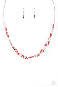 A dainty collection of faceted silver beads, red seed beads, and silver cubes are threaded along multiple strands of silver wire below the collar, creating clustered layers. Features an adjustable clasp closure.  Sold as one individual necklace. Includes one pair of matching earrings.