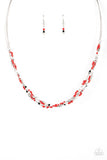 A dainty collection of faceted silver beads, red seed beads, and silver cubes are threaded along multiple strands of silver wire below the collar, creating clustered layers. Features an adjustable clasp closure.  Sold as one individual necklace. Includes one pair of matching earrings.