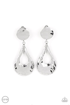 A hammered silver teardrop swings from the bottom of a hammered silver disc, resulting in monochromatic magic. Earring attaches to a standard clip-on fitting.
