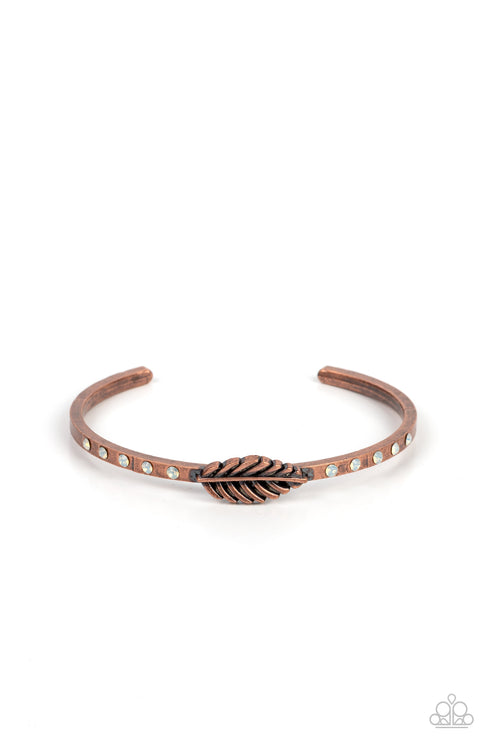 Bordered by rows of opaque opal rhinestones, a dainty copper feather frame is pressed into the center of a dainty copper cuff for a free-spirited finish.  Sold as one individual bracelet.