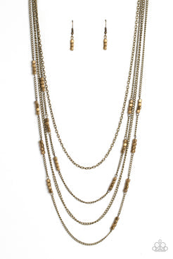 Glistening brass chains, sporadically infused with a quartet of brass beads link into fashionable layers below the neckline for a monochromatic medley. Features an adjustable clasp closure.  Sold as one individual necklace. Includes one pair of matching earrings.