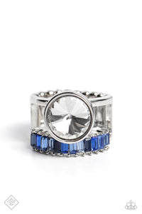 A row of glitzy, emerald-cut, blue rhinestones flares out from the bottom of an airy silver frame, while an oversized classic white gem crowns the top of the design, creating a smoldering statement piece atop the finger. Features a stretchy band for a flexible fit.  Sold as one individual ring.