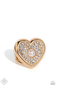 Pressed in a sleek, gold heart frame, brilliant white rhinestones encapsulate around a pearly center for a classic, heartfelt centerpiece atop the finger. Features a stretchy band for a flexible fit. Sold as one individual ring.