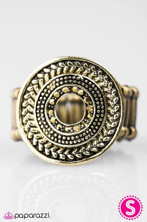 A warped brass frame crowns the finger in a bold industrial fashion. Embossed in stunning textures, the center of the airy display is encircled in radiant brass rhinestones for an edgy finish. Sold as one individual ring.