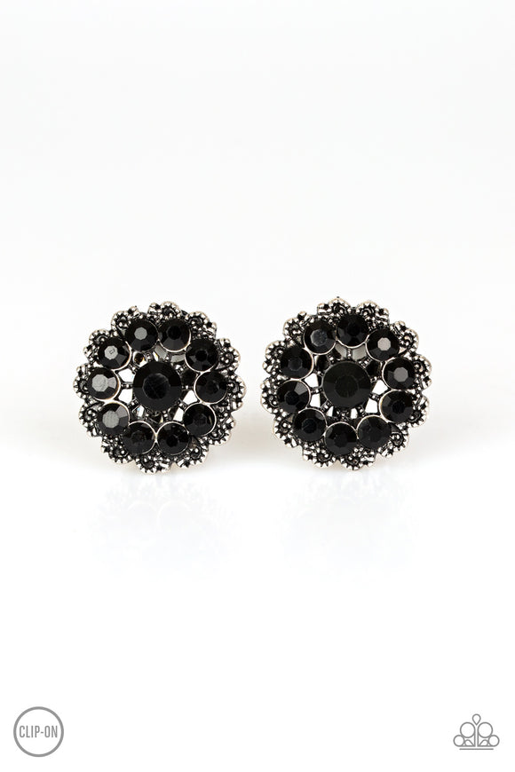 Dotted silver filigree spins around a black rhinestone encrusted center, swirling into a refined floral frame. Earring attaches to a standard clip-on fitting.  Sold as one pair of clip-on earrings.