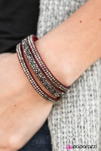 Hematite and smoky prisms are sprinkled along the center of a red suede band. Rows of dainty hematite rhinestones flank the sparkly center, creating an edgy stacked look around the wrist. Features an adjustable snap closure.  Sold as one individual bracelet