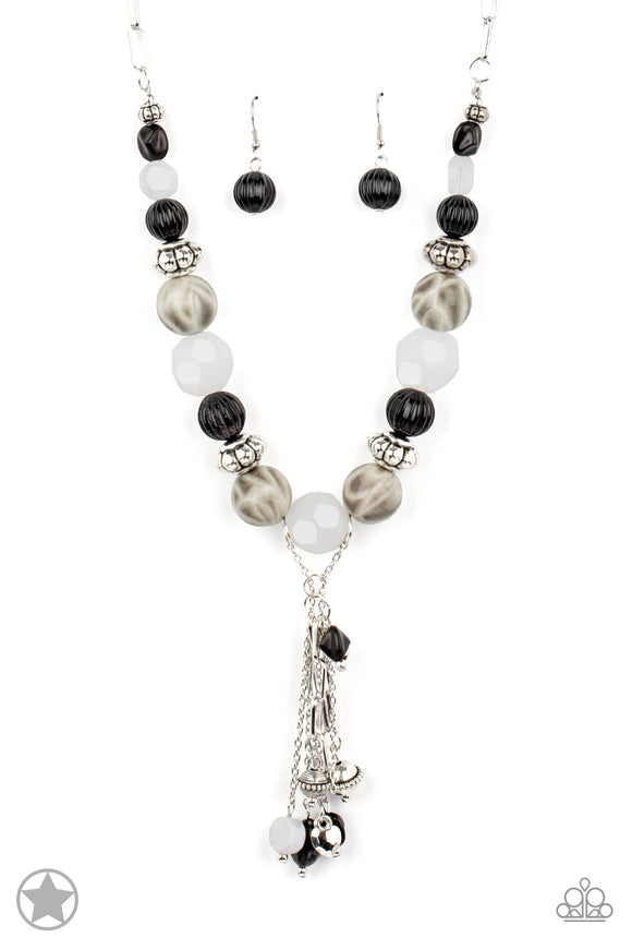 Smooth beads with a marbleized black and white swirl alternate with milky white and silver accents. A tassel of chains in various lengths is decorated with black, silver, and frosty pieces. Features an adjustable clasp closure.  Sold as one individual necklace. Includes one pair of matching earrings.