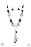 Smooth beads with a marbleized black and white swirl alternate with milky white and silver accents. A tassel of chains in various lengths is decorated with black, silver, and frosty pieces. Features an adjustable clasp closure.  Sold as one individual necklace. Includes one pair of matching earrings.