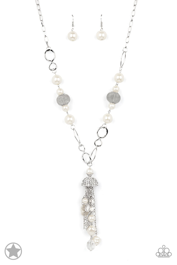 A half-shell studded in rhinestones overhangs a cluster of ivory pearls, tassels of silver chain, and small crystals. Two large wire mesh spheres and larger ivory pearls decorate the neckline.  Sold as one individual necklace. Includes one pair of matching earrings.