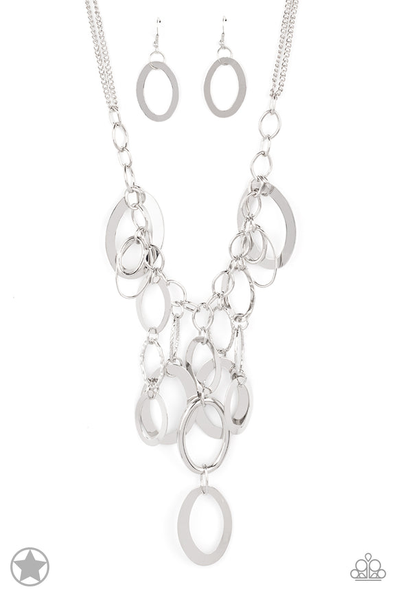 Large silver links and shimmering textured silver rings cascade below a silver chain freely, allowing for movement that makes a bold statement. Features an adjustable clasp closure.  Sold as one individual necklace.Includes one pair of matching earring. Blockbuster