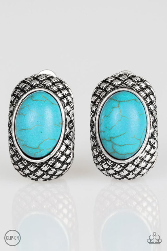 A refreshing turquoise stone is pressed into a silver frame radiating with tactile textures for a seasonal look. Earring attaches to a standard clip-on fitting. Sold as one pair of clip-on earrings.