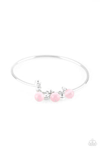 Glassy pink beads and glittery white rhinestones slide along a dainty silver wire infused with a rhinestone encrusted fitting, creating a versatile adjustable like bangle. Features a hinged closure.  Sold as one individual bracelet.