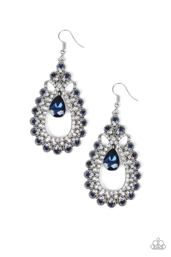 A blue teardrop gem swings from the top of a frilly silver frame radiating with glassy white and glittery blue rhinestone encrusted petals for a regal look. Earring attaches to a standard fishhook fitting.  Sold as one pair of earrings.