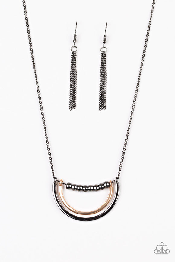A strand of shiny gunmetal beads give way to bowing gold and gunmetal frames, creating an edgy pendant below the collar. Features an adjustable clasp closure.  Sold as one individual necklace. Includes one pair of matching earrings.