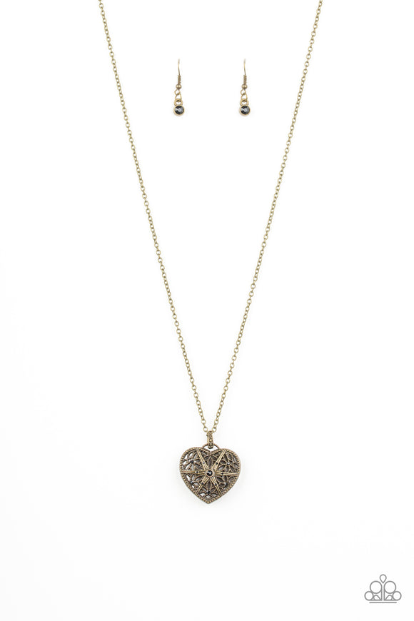 Encrusted in glittery black rhinestones, a vintage inspired heart pendant swings from the bottom of a shimmery brass chain for a romantic fashion. Features an adjustable clasp closure.  Sold as one individual necklace. Includes one pair of matching earrings.