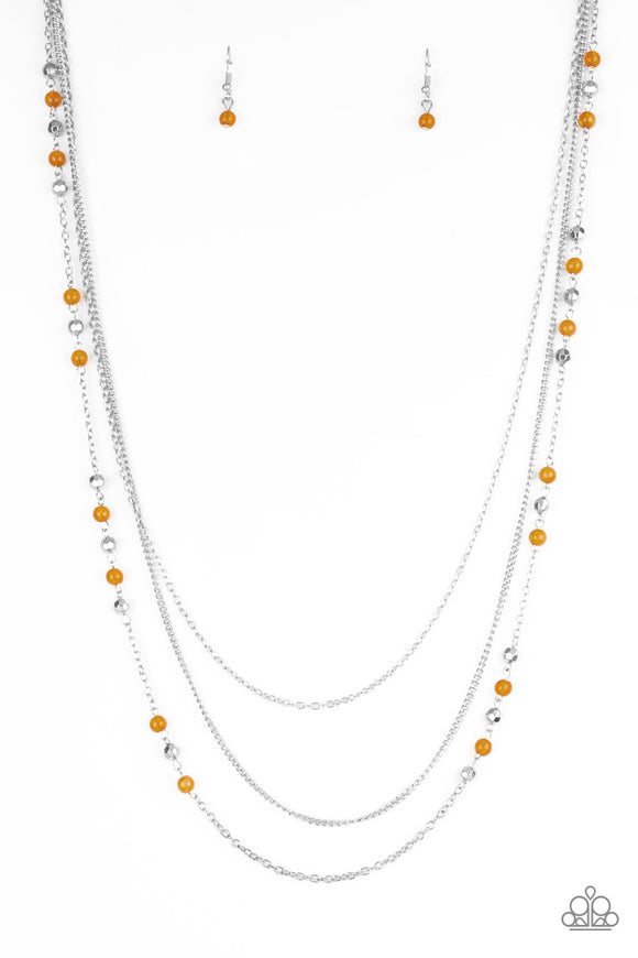 Faceted silver and glassy orange beads trickle along shimmery silver chains down the chest for a whimsical look. Features an adjustable clasp closure.  Sold as one individual necklace. Includes one pair of matching earrings.