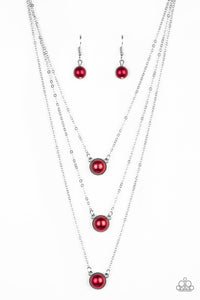 Three red pearl drop pendants layer down the chest in a refined fashion. Features an adjustable clasp closure.  Sold as one individual necklace. Includes one pair of matching earrings.