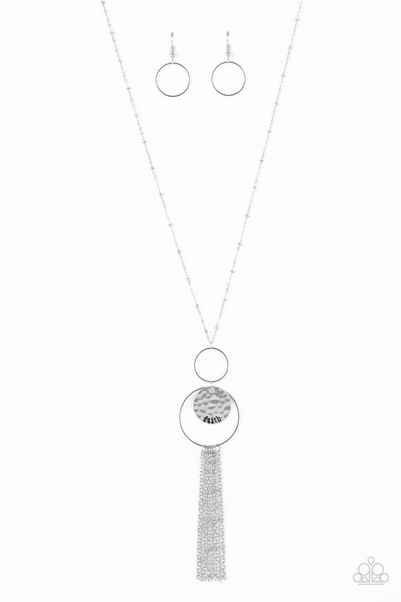 A delicately hammered silver disc is stamped in the inspirational word, 