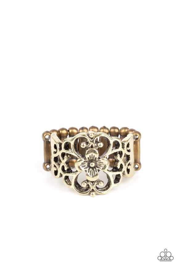 Glistening brass filigree blooms from a shimmery floral center, creating a whimsical band across the finger. Features a stretchy band for a flexible fit.  Sold as one individual ring.