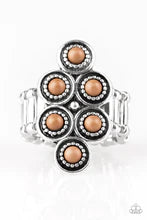 Dainty brown stones are pressed into ornate silver frames, coalescing into an earthy frame atop the finger. Features a stretchy band for a flexible fit. Sold as one individual ring.