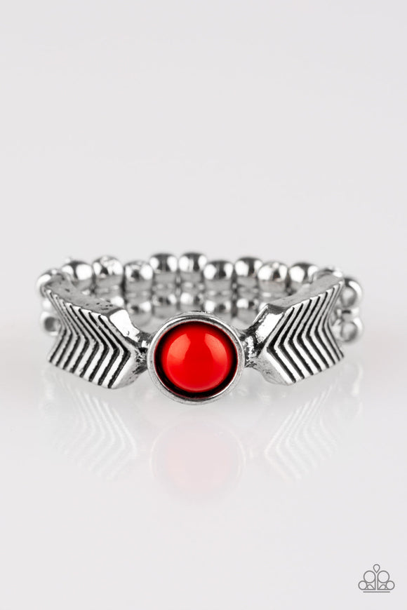 Chevron-like frames join into a dainty band, creating metallic arrows. A dainty red bead adorns the center of the band for a seasonal finish. Features a dainty stretchy band for a flexible fit.  Sold as one individual ring.