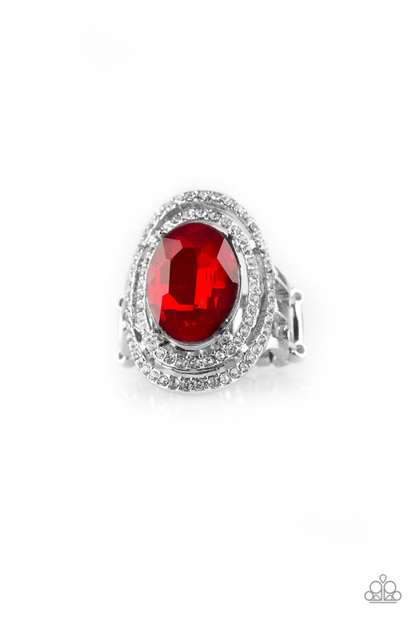 A glittery red gem sits atop stacked silver frames radiating with glassy white rhinestones for a timeless look. Features a stretchy band for a flexible fit.  Sold as one individual ring.