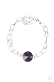 A dramatic purple gem attaches to a shiny silver chain, creating a blinding centerpiece atop the wrist. Features a toggle closure.  Sold as one individual bracelet.