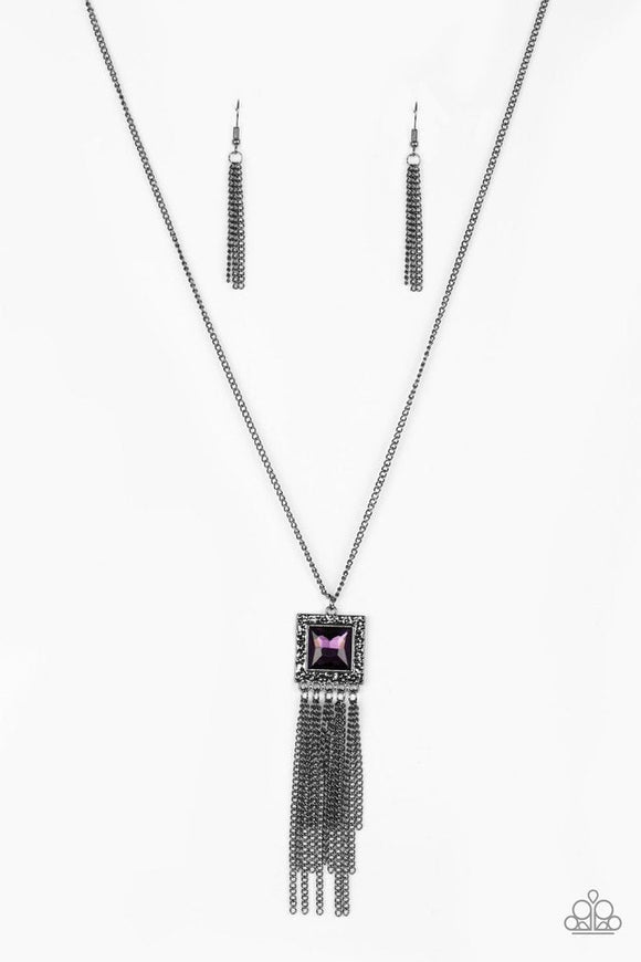 Swinging from the bottom of a lengthened gunmetal chain, a delicately hammered square frame gives way to a shimmery gunmetal fringe. Featuring a regal square cut, a glittery purple gem is pressed into the center of the pendant for an edgy look