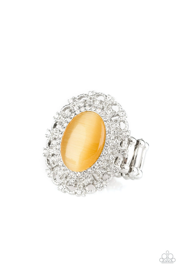Encrusted in dainty white rhinestones, a frilly silver frame spins around a glowing yellow moonstone center for a regal look. Features a stretchy band for a flexible fit.  Sold as one individual ring.