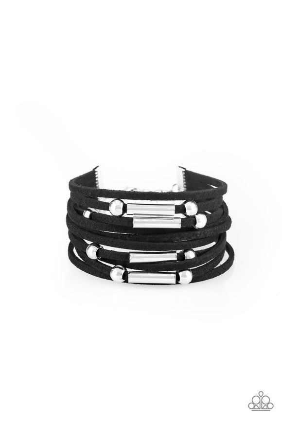 Strung between two silver fittings, glistening silver accents slide along strands of black suede for a seasonal look. Features an adjustable clasp closure.  Sold as one individual bracelet.