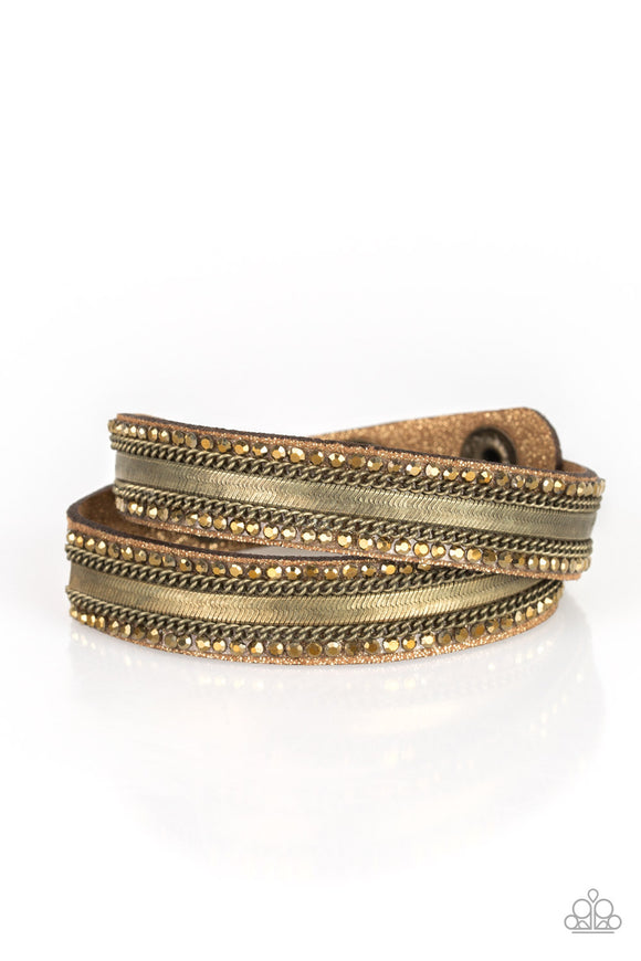 Rows of classic brass chain, flat brass chain, and dainty aurum rhinestones are encrusted along a brown suede band dusted in golden sparkles for a sassy look. The elongated band allows for a trendy double wrap design. Features an adjustable snap closure.  Sold as one individual bracelet.