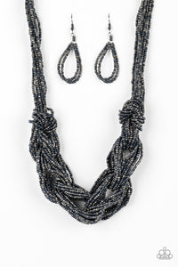 Brushed in a flashy metallic finish, countless strands of blue and gunmetal seed beads weave into a bulky square braid below the collar for a glamorous look. Features an adjustable clasp closure.  Sold as one individual necklace. Includes one pair of matching earrings.