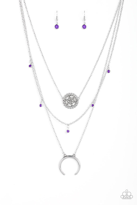 A silver floral frame swings from the uppermost chain, above a strand of faceted purple beads swinging from a shimmery silver chain. A silver crescent frame swings from the lowermost chain, creating whimsical layers down the chest. Features an adjustable clasp closure.  Sold as one individual necklace. Includes one pair of matching earrings.