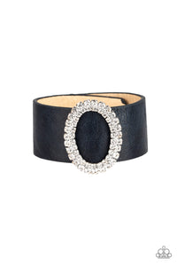 Encrusted in glassy white rhinestones, a round silver frame slides along a thick blue leather band for a glamorous look. Features an adjustable snap closure.  Sold as one individual bracelet.