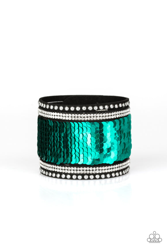 Shiny silver studs, glassy white rhinestones, and shimmering sequins are sprinkled across a thick black suede band that has been spliced into five glittery rows. Bracelet features reversible sequins that change from green to silver. Features an adjustable snap closure.  Sold as one individual bracelet.