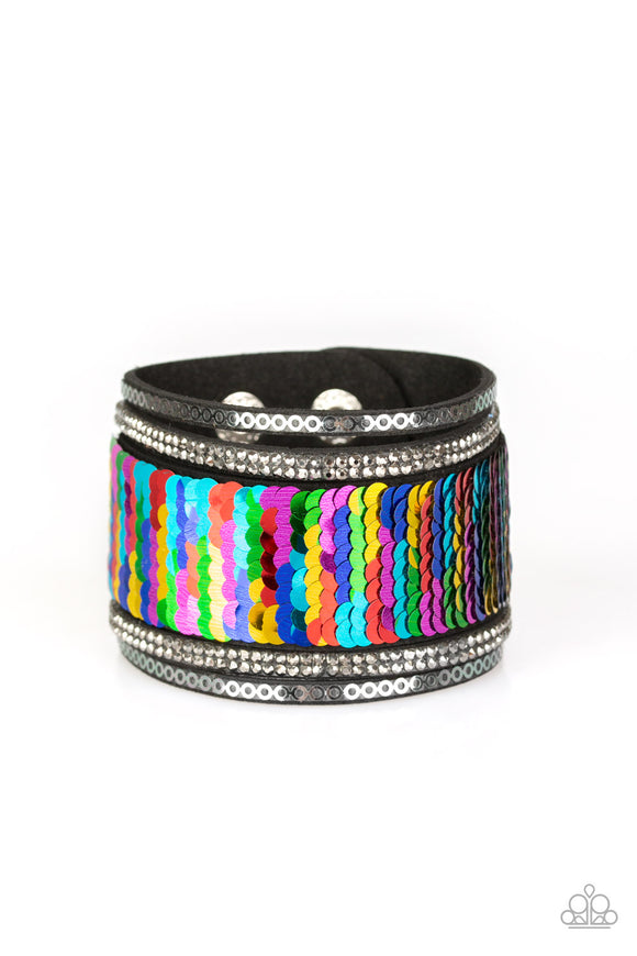 Infused with strands of smoky hematite rhinestones and dainty metallic accents, row after row of shimmery sequins are stitched across the front of a spliced black suede band. Bracelet features reversible sequins that change from multicolored to silver. Features an adjustable snap closure.  Sold as one individual bracelet.